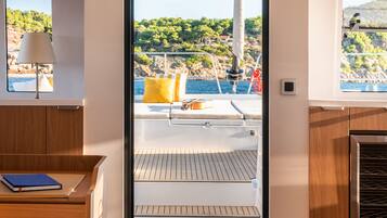 A modern interior with a view of the deck and water.