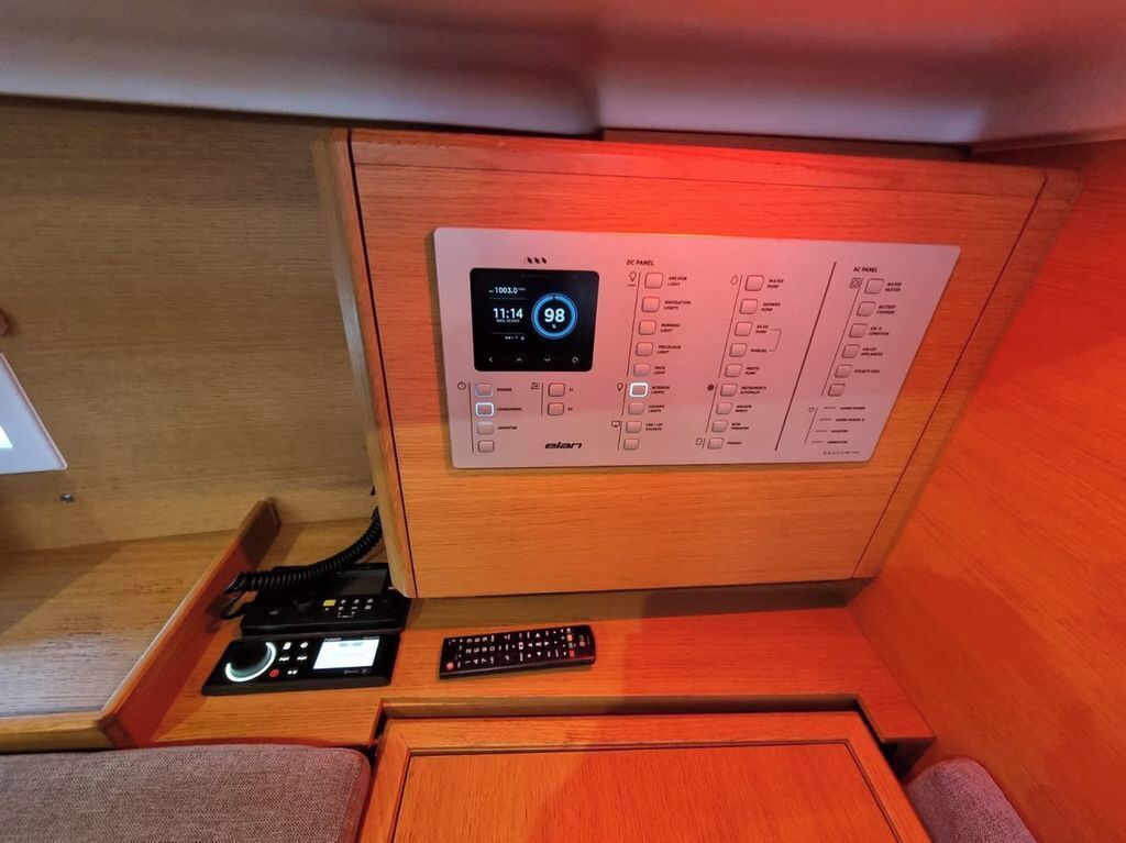 A control panel with a digital clock, AC power switch, and remote controls.