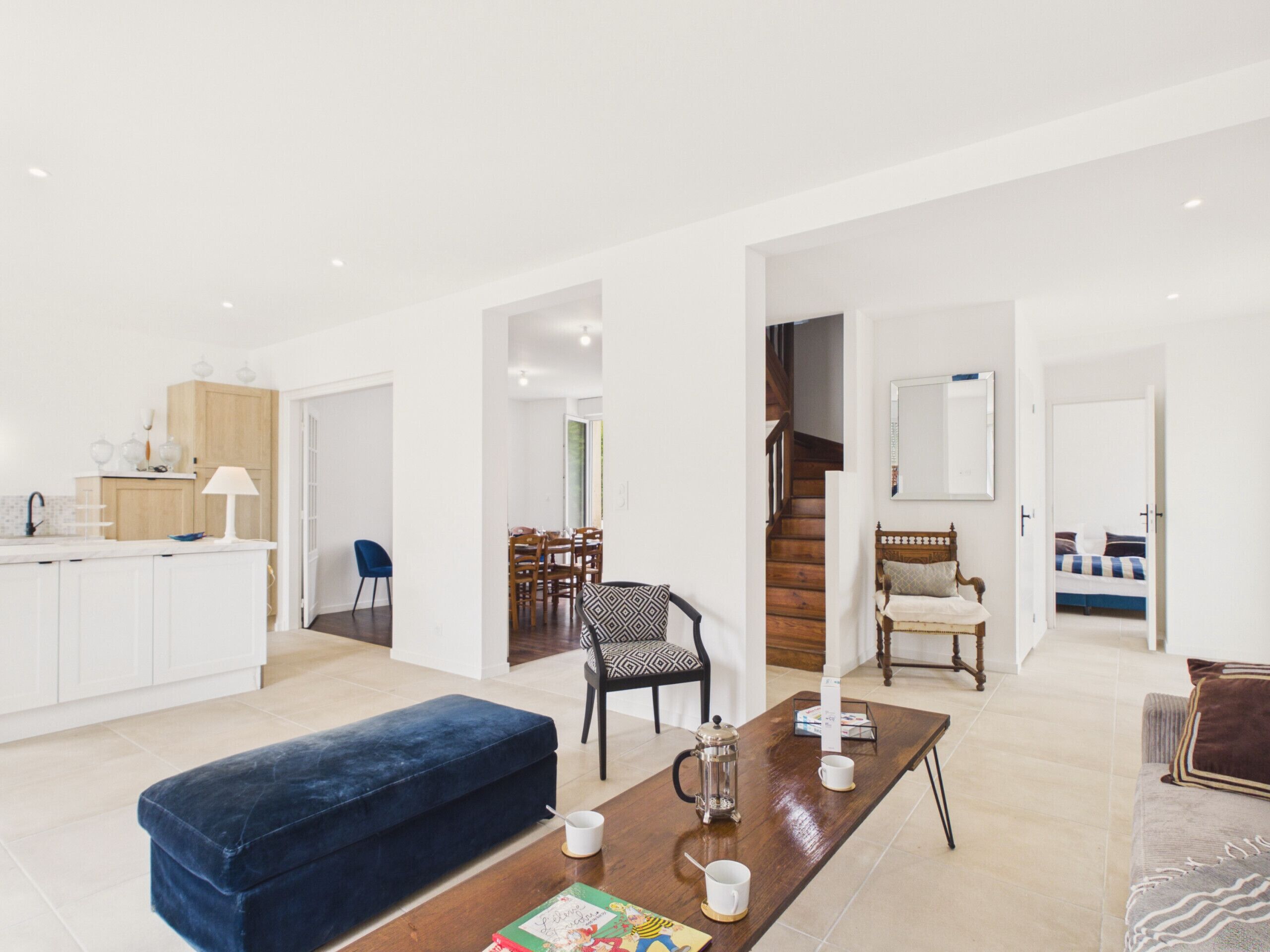 A modern living space with a kitchen, dining area, and a bedroom.