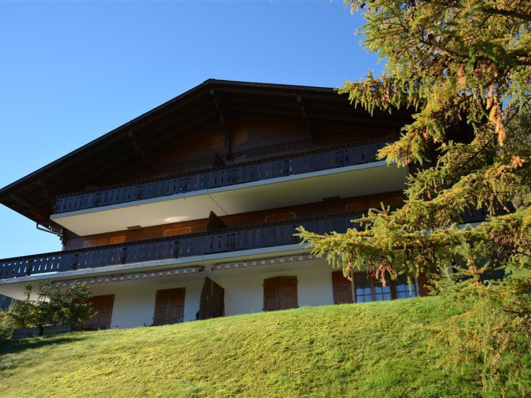 A multi-story building with a traditional architectural style, featuring a balcony on the upper floor and a sloped roof.