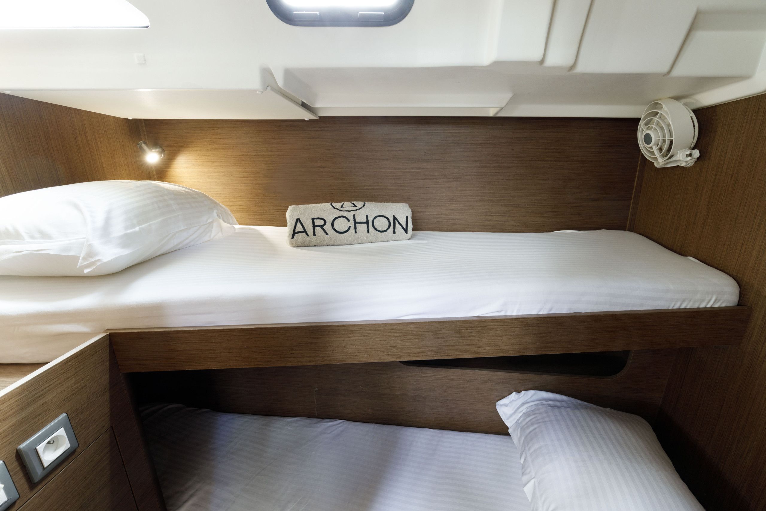 A bunk bed with a sign reading 'ARCHON' on the headboard.