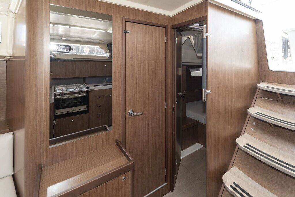 A compact kitchenette with a stove, oven, and cabinets.