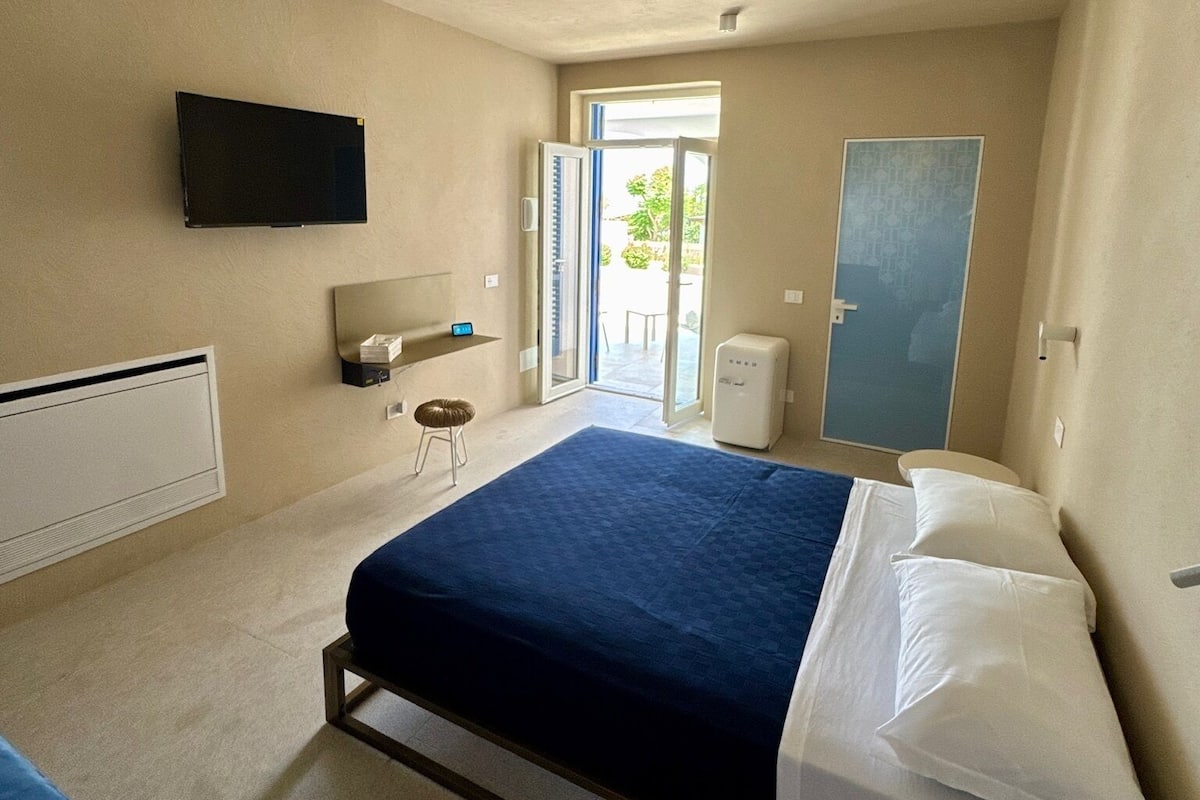 Junior Triple Room, Partial Sea View | Minibar, in-room safe, desk, laptop workspace