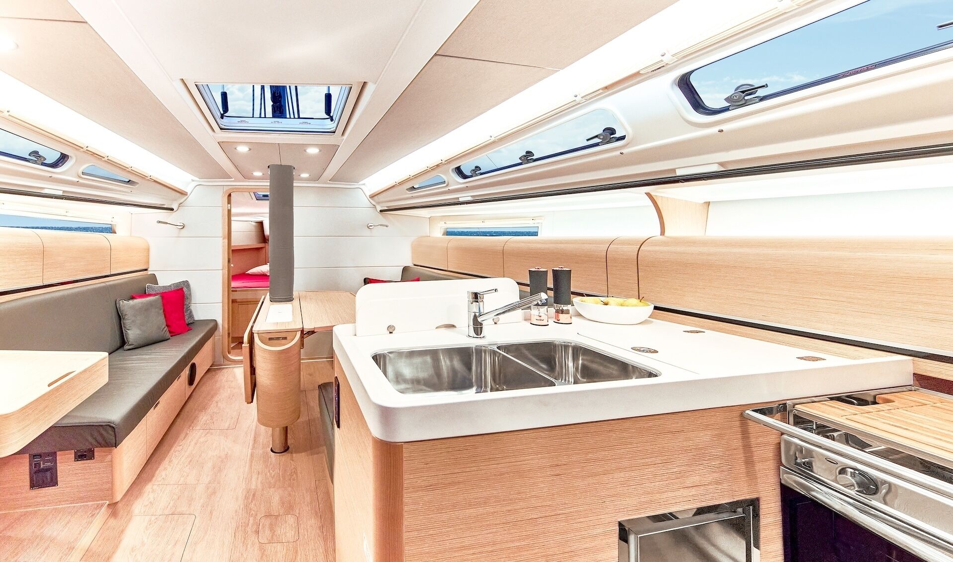 Un intérieur de camping-car moderne comprenant un coin cuisine, des sièges et un espace repas.