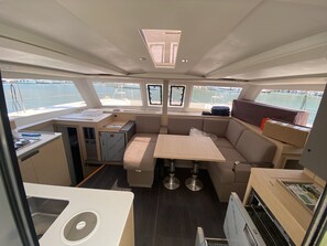 A compact galley with a sink, stove, and storage cabinets. - Sun-Kissed Sailing Adventure in the Ionian Islands, Lefkada (Lefkada)