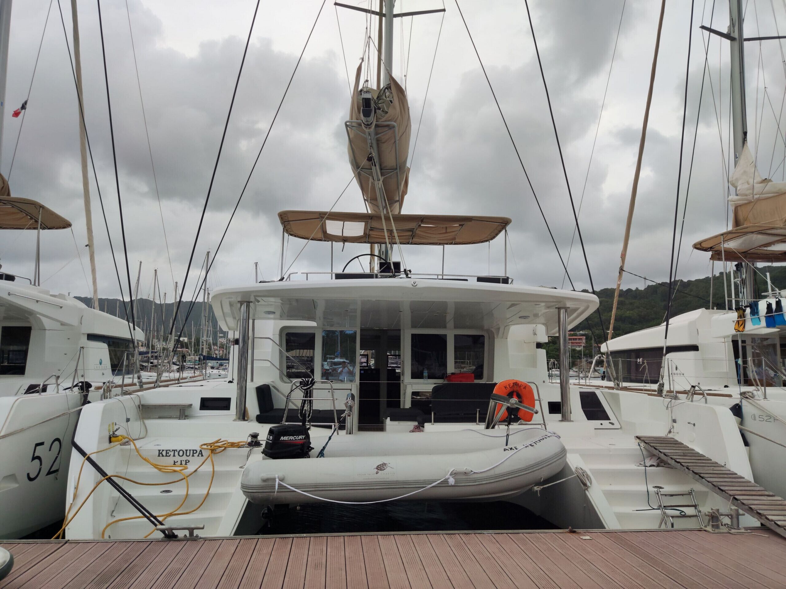 A boat with a cabin, a steering wheel, and a lifebuoy.
