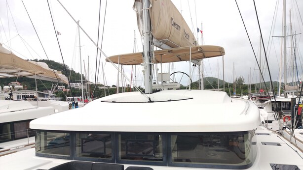 A yacht with a covered deck area, a seating arrangement, and a sail. - Caribbean Sun-Kissed Sailing: A Luxurious Beach Experience from Martinica, Le Marin (Le Marin)