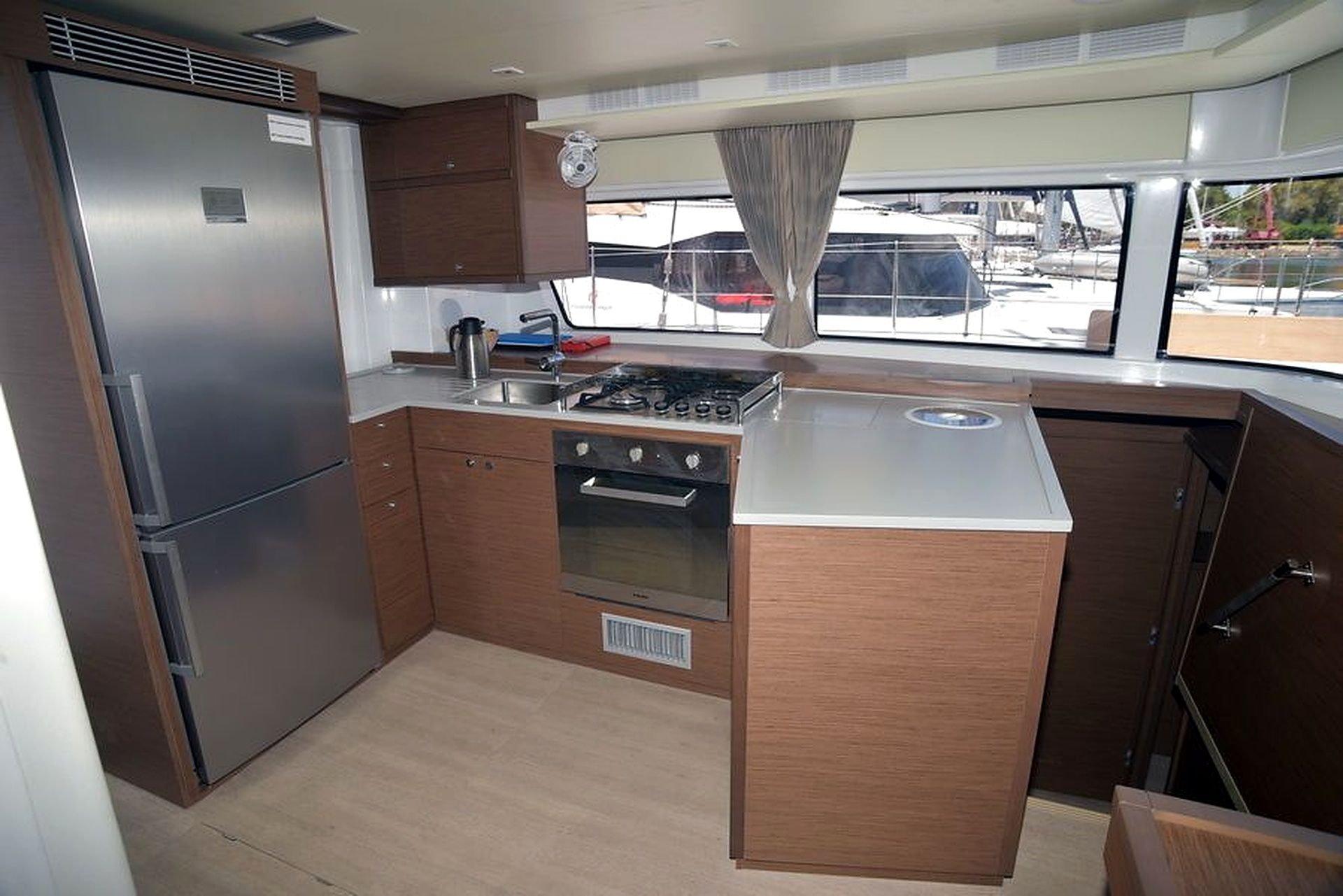 A compact kitchen with a refrigerator, stove, and sink.