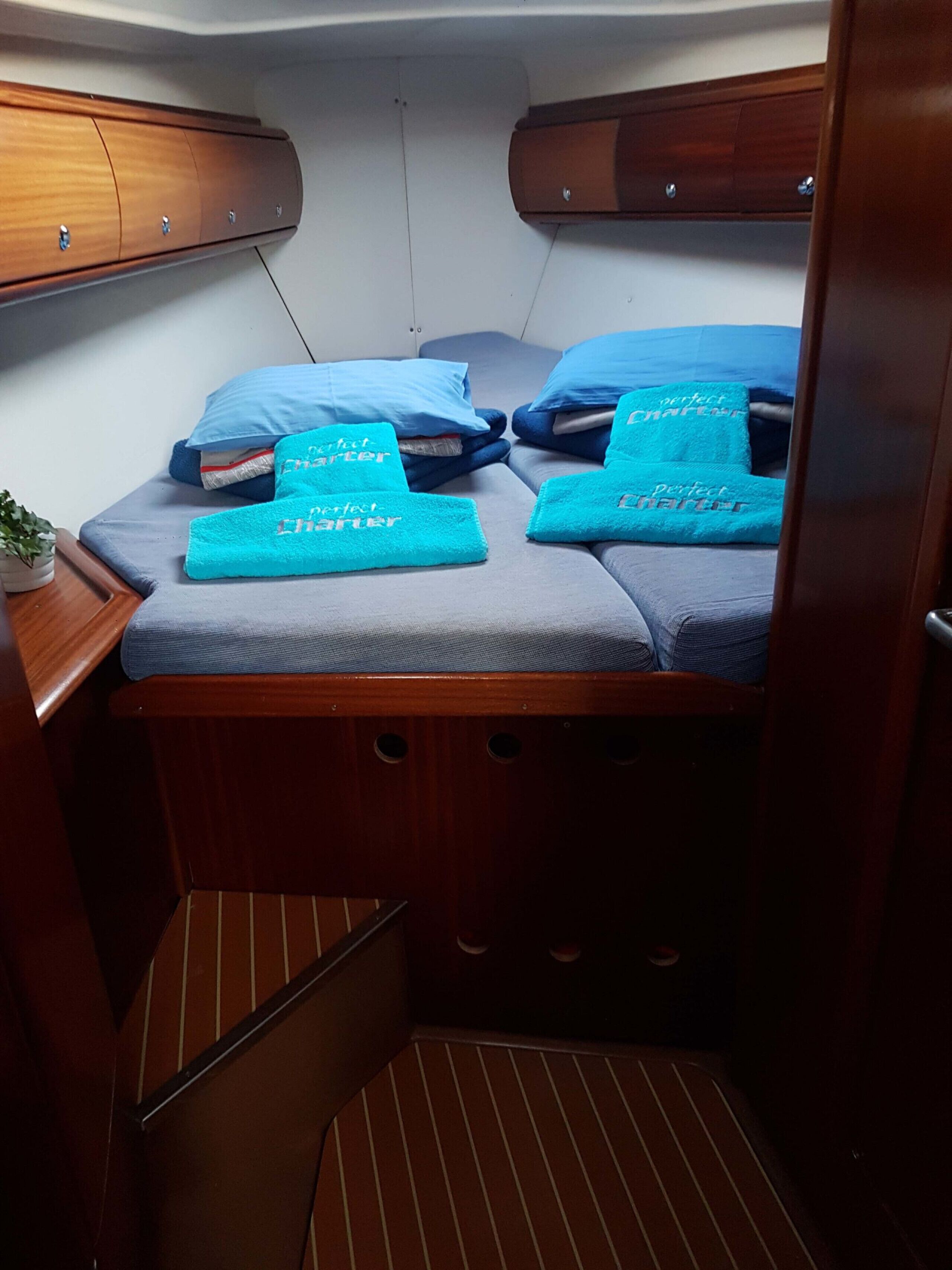 A compact cabin with a bed, two pillows, and a small seating area.