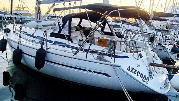 A sailboat named 'BAVARIA 41' docked at a marina with other boats. - Sun-Kissed Sailing Adventure in Northern Croatia (Punat)