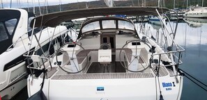 A boat deck with two steering wheels, a central console, and a name 'Diana I' on the starboard side.