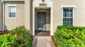 A house with a number '4591A' above the door, a front porch, and a small window on the left. - 2BR Legends Golf Villa - Ground Floor - Pond View (Myrtle Beach)