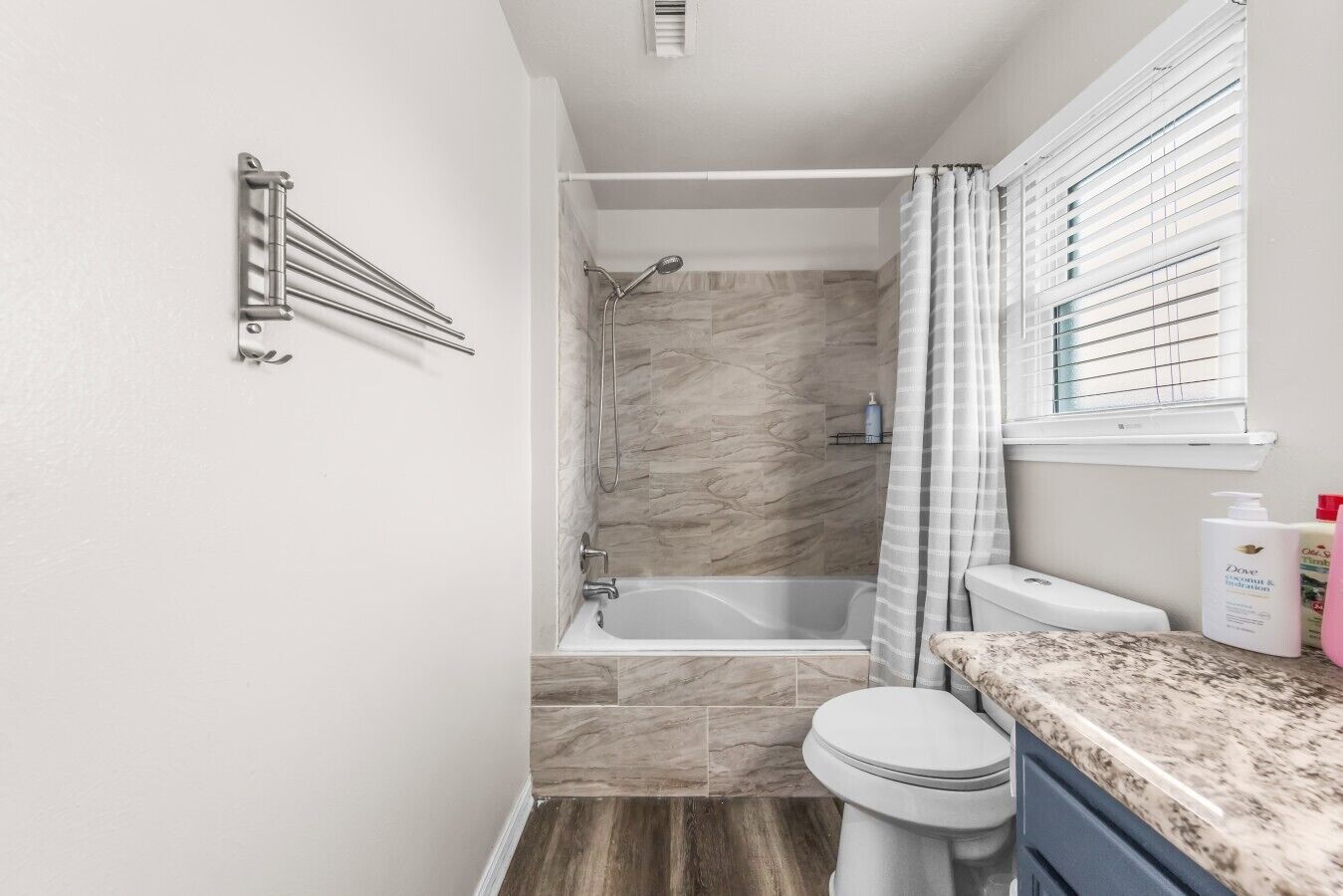 A bathroom with a bathtub, toilet, and shower.