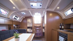 A compact RV interior with a kitchenette, a dining area, and a sleeping berth. - Sun-Kissed Sailing Adventure in Zadar, Croatia (Zadar)