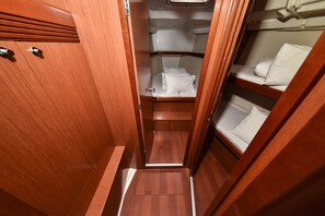 A narrow corridor with wooden walls and a bunk bed on the right. - Sun-Kissed Sailing Adventure in Zadar, Croatia (Bibinje)
