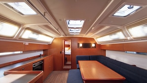 A compact galley with a wooden table, bench seating, and skylights. - Sun-Kissed Sailing Adventure in Split, Croatia (Split)
