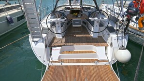 A boat's deck with a wooden floor, a steering wheel, and a Suzuki outboard motor. - Sun-Kissed Sailing Adventure in the Sporades Islands from Volos, Thessaly (Volos)