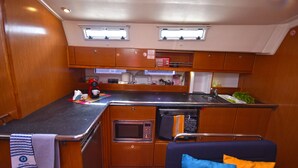 A compact kitchen with a microwave, sink, and small countertop space. - Sun-Kissed Sailing Adventure in the Sporades Islands from Volos, Thessaly (Volos)
