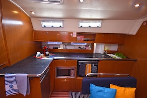 A compact kitchen with a microwave, sink, and small countertop space. - Sun-Kissed Sailing Adventure in the Sporades Islands from Volos, Thessaly (Volos)