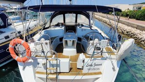 A boat named 'Lady Joanna' docked at a marina with a clear water view, a wooden deck, and life rings. - Sun-Kissed Sailing Adventure in Zadar, Croatia (Bibinje)