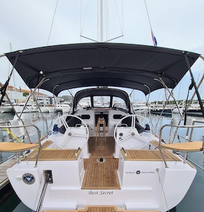 A yacht with a covered deck, a steering wheel, and a logo that reads 'WORLD YACHTING'. - Sun-Kissed Sailing Adventure in Northern Croatia (Punat)