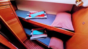 A compact, well-organized cabin with a bunk bed, a small desk, and a storage cabinet. - Sun-Kissed Sailing Adventure in Northern Croatia (Punat)