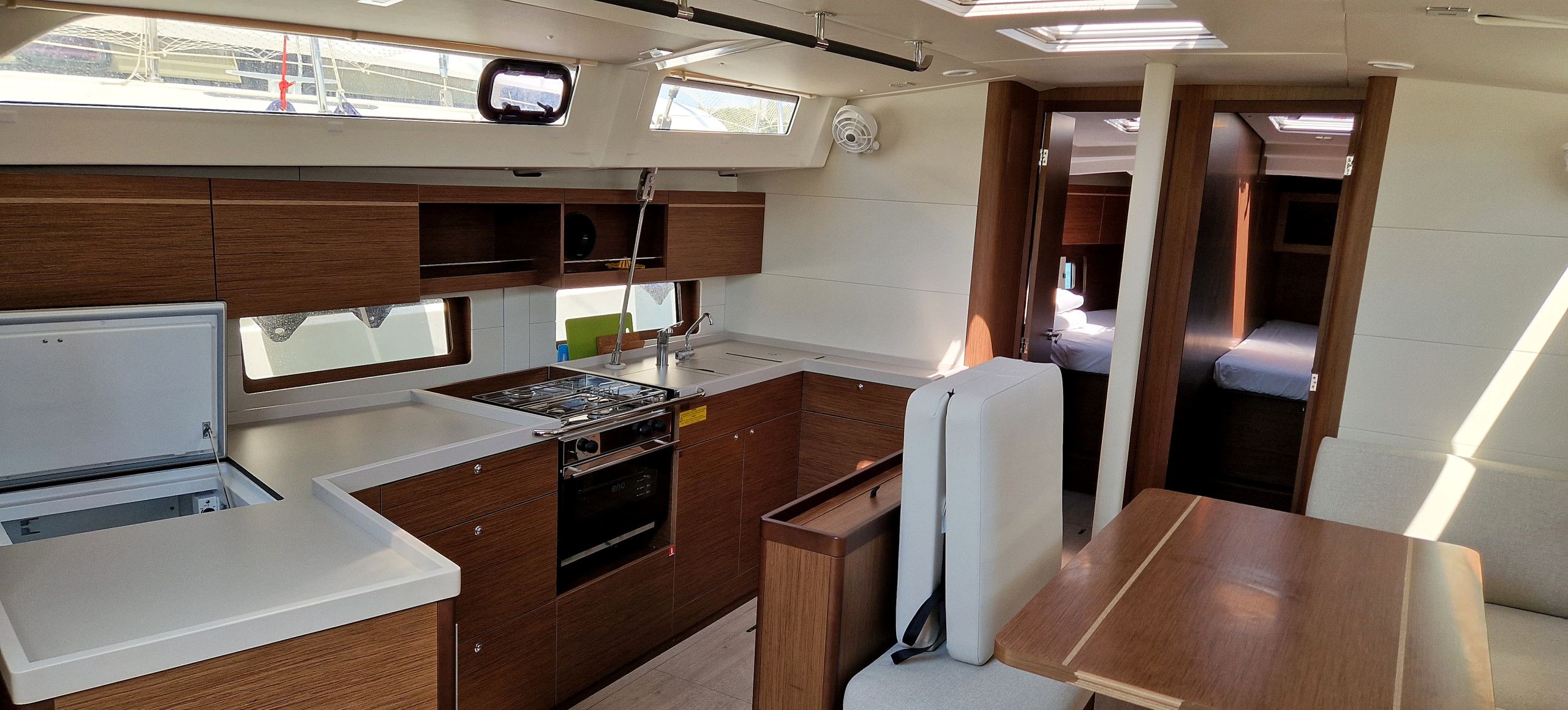 A compact kitchen with a stove, sink, and storage cabinets.