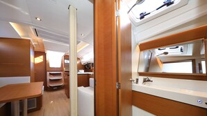 A compact, well-lit interior with a wooden vanity, a sink, and a mirror. - Sun-Kissed Sailing Adventure in Zadar, Croatia (Zadar)