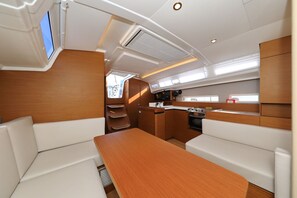 A compact kitchen with a sink, stove, and storage cabinets. - Sun-Kissed Sailing Adventure in Zadar, Croatia (Zadar)