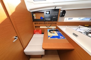 A compact boat interior with a control panel, a small seating area, and a sink. - Sun-Kissed Sailing Adventure in Zadar, Croatia (Zadar)