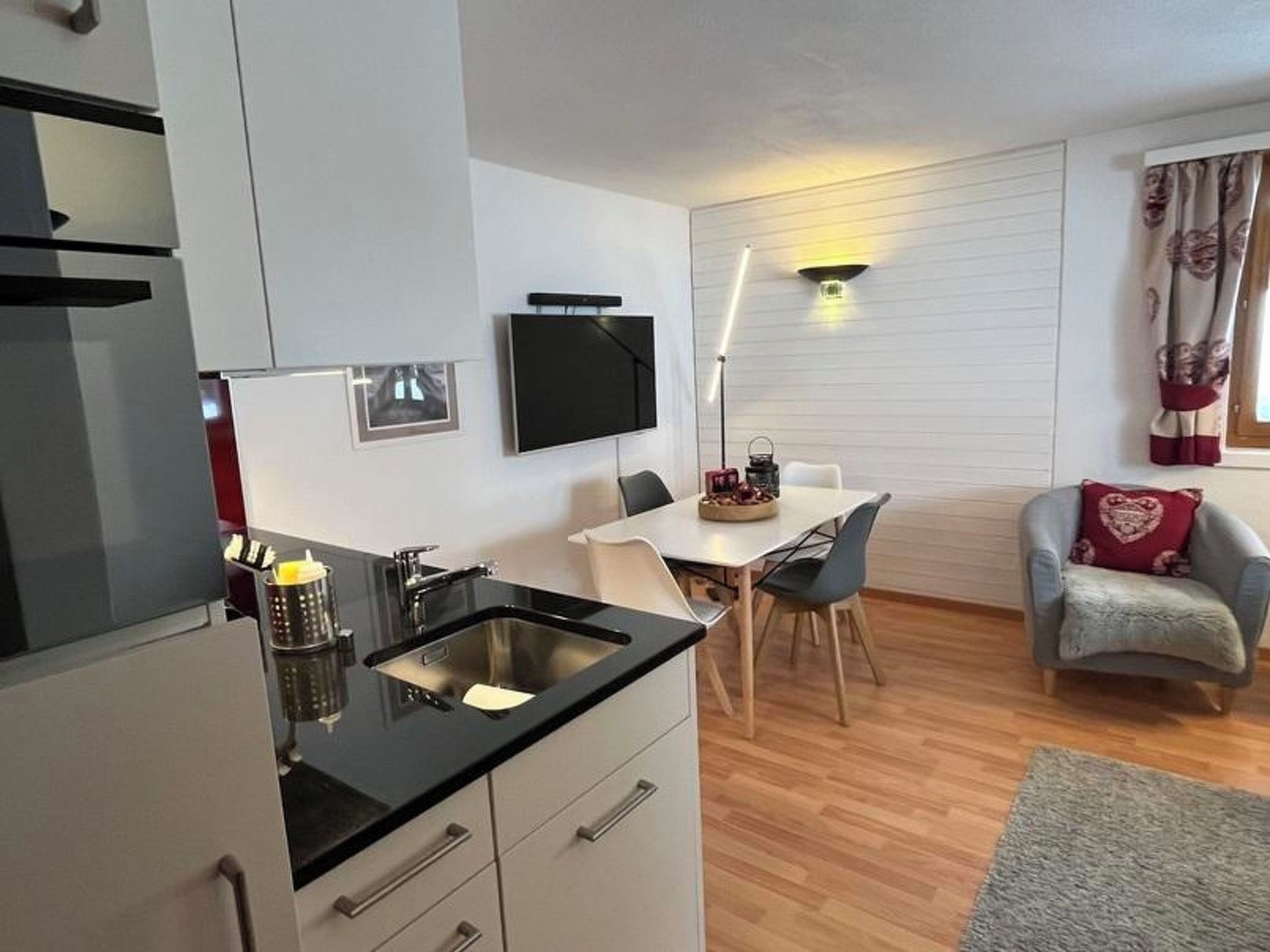 A compact living space with a kitchenette, dining area, and seating area.