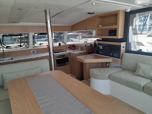A compact galley with a stove, sink, and storage cabinets. - Sun-Kissed Sailing Adventure in the Ionian Islands, Lefkada (Lefkada)