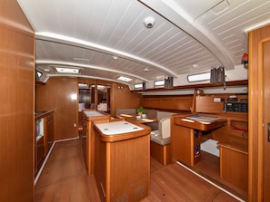 A compact, well-lit interior with a dining area, a control panel, and a seating area. - Sun-Kissed Sailing Adventure in Zadar, Croatia (Bibinje)
