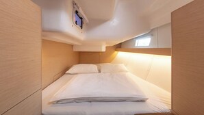 A compact, well-lit cabin with a bunk bed, wooden paneling, and a small window. - Sun-Kissed Sailing Adventure in Split, Croatia (Split)