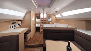 A compact interior with a kitchenette, seating area, and a central aisle. - Sun-Kissed Sailing Adventure in Split, Croatia (Split)