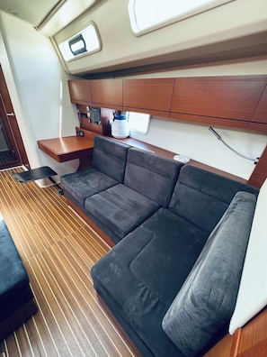 A compact interior with a sofa, a small table, and a microwave.