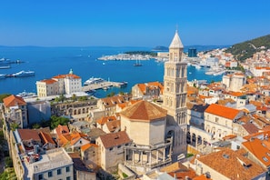 A coastal town with historic architecture, a prominent tower, and a marina with boats. - Sun-Kissed Sailing Adventure in Split, Croatia (Split)