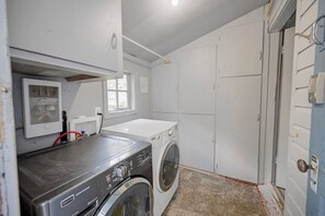 A laundry room with a washing machine, dryer, and a utility room with a heater. - Quaint cabin at the Lake (Sylvan Lake)