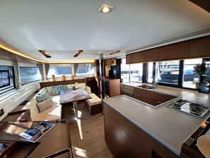 A modern interior with a dining area, kitchen, and seating.