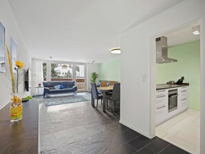 A modern interior with a dining area, kitchen, and living space. - Nr.14 Haus Astoria Appartement/Fewo Nr.14 Haus Astoria by Interhome (Lenzerheide)