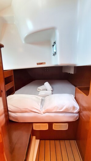 A compact cabin with a bunk bed, a small sink, and a wooden floor. - Sun-Kissed Sailing Adventure in the Sporades Islands from Volos, Thessaly (Volos)