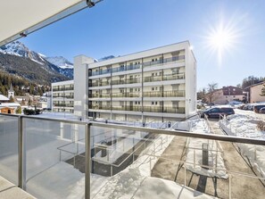 A modern multi-story hotel with a glass facade, located in a mountainous area with snow-covered ground. - Nr.06 Haus Sursilvana Appartement/Fewo,   Nr.06 Haus Sursilvana by Interhome (Lenzerheide)
