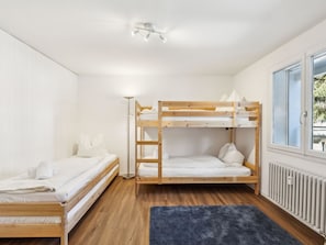 A bunk bed room with a radiator, a window with a view, and a floor lamp. - Nr.06 Haus Sursilvana Appartement/Fewo,   Nr.06 Haus Sursilvana by Interhome (Lenzerheide)
