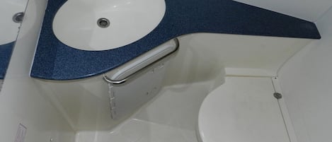 A bathroom with a white sink, a toilet, and a bathtub.