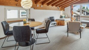 A modern interior with a dining area, seating, and a view of the outside.