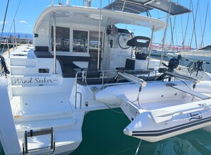 A white yacht named 'Wind Seeker SPLIT' docked at a marina with other boats in the background. - Sun-Kissed Sailing Adventure in Split, Croatia (Split)