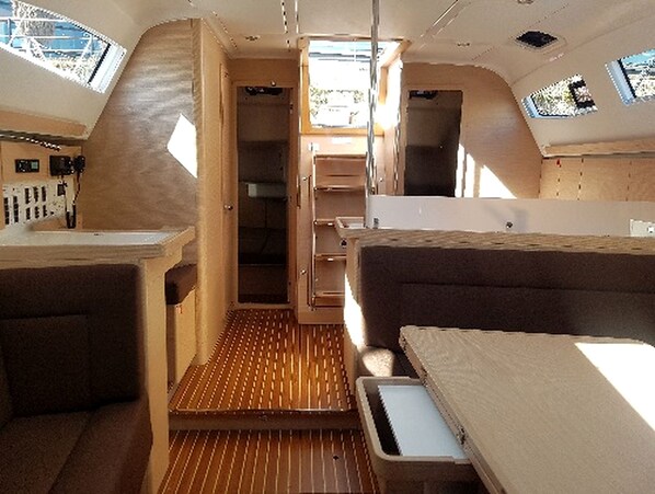 A compact interior with a kitchenette, a seating area, and a window providing natural light.