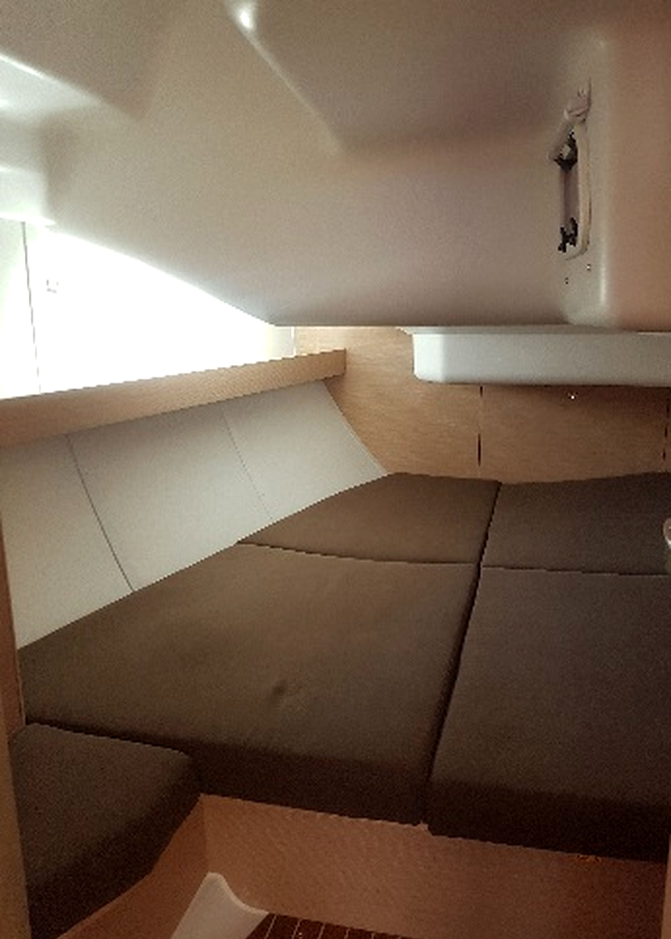 A compact seating area with a bench and a small table, likely a galley or dining space.