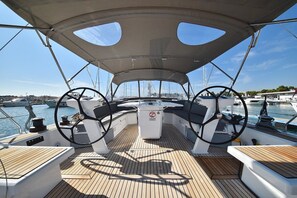 A boat deck with two steering wheels, a central console, and a canopy overhead. - Sun-Kissed Sailing Adventure in Zadar, Croatia (Zadar)