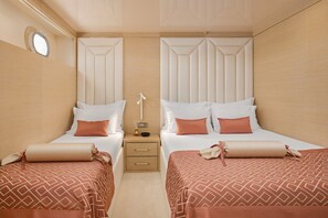 A hotel room with two beds, a nightstand with a lamp, and a small window. - Sun-Kissed Sailing Adventure in Split, Croatia (Split)